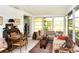 Bright sunroom with ample natural light, cozy seating, and a view of the lush outdoors at 6504 Heritage Ln # 99, Bradenton, FL 34209