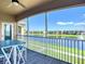 Screened-in balcony with table and view of community lake and landscaping at 6604 7Th Avenue W Cir, Bradenton, FL 34209