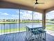 Screened balcony with seating offering serene lake view at 6604 7Th Avenue W Cir, Bradenton, FL 34209