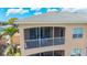 Exterior view of a screened-in balcony with seating area on the second floor at 6604 7Th Avenue W Cir, Bradenton, FL 34209