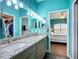 Well-lit bathroom features double sinks, granite counters, and lots of storage at 6604 7Th Avenue W Cir, Bradenton, FL 34209
