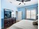 Bedroom with ceiling fan, dresser with TV, and great natural light at 6604 7Th Avenue W Cir, Bradenton, FL 34209