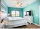 Bright bedroom with a large window, TV on dresser, and ceiling fan at 6604 7Th Avenue W Cir, Bradenton, FL 34209