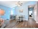 Dining area featuring blue walls, hardwood floors, and a modern ceiling fan, perfect for cozy meals at 6604 7Th Avenue W Cir, Bradenton, FL 34209