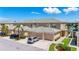 View of three attached townhomes with a shared driveway and tile roof on a sunny day at 6604 7Th Avenue W Cir, Bradenton, FL 34209