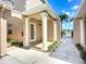 Front entrance with white columns, a white door, and manicured landscaping in a well-maintained community at 6604 7Th Avenue W Cir, Bradenton, FL 34209