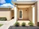 Inviting front entrance featuring decorative columns, manicured shrubs, and a well-lit porch for a welcoming appeal at 6604 7Th Avenue W Cir, Bradenton, FL 34209