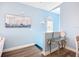 Hallway with blue accent wall, wood floors, and stylish decor for an elegant and welcoming ambiance at 6604 7Th Avenue W Cir, Bradenton, FL 34209