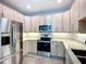 Modern kitchen with stainless steel appliances and granite countertops at 6604 7Th Avenue W Cir, Bradenton, FL 34209