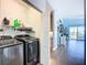 Laundry room featuring modern washer, dryer, and storage shelves at 6604 7Th Avenue W Cir, Bradenton, FL 34209