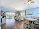Bright, open living room features sliding glass doors to balcony and ceiling fans at 6604 7Th Avenue W Cir, Bradenton, FL 34209