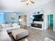 Open living room with modern furniture, hardwood floors, and a sleek TV stand for comfortable living at 6604 7Th Avenue W Cir, Bradenton, FL 34209