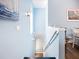 Stylish staircase with blue walls, elegant lighting, and hardwood flooring leading to the lower level at 6604 7Th Avenue W Cir, Bradenton, FL 34209