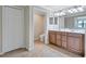 Well-lit bathroom features double sinks, a spacious vanity, and a separate toilet area at 6918 Grand Estuary Trl # 104, Bradenton, FL 34212