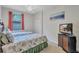 Cozy bedroom with twin beds, soft lighting, and a view of a large television at 6918 Grand Estuary Trl # 104, Bradenton, FL 34212