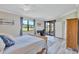 Bright bedroom with large window overlooking the golf course and sliding glass door leading to the patio at 6918 Grand Estuary Trl # 104, Bradenton, FL 34212