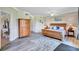 Light and airy bedroom boasts a wooden bed frame, complemented by neutral tones and ample natural light at 6918 Grand Estuary Trl # 104, Bradenton, FL 34212