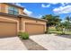 This home features a two-car garage, a paver driveway, and well-maintained landscaping at 6918 Grand Estuary Trl # 104, Bradenton, FL 34212