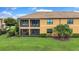 Exterior of the condo showcasing the screened balconies with outdoor space at 6918 Grand Estuary Trl # 104, Bradenton, FL 34212