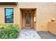 Charming front entrance with brick walkway, decorative glass door, and fresh landscaping at 6918 Grand Estuary Trl # 104, Bradenton, FL 34212