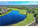 Picturesque aerial view of the community golf course and serene lake at 6918 Grand Estuary Trl # 104, Bradenton, FL 34212