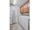 Functional laundry room equipped with washer, dryer, and above cabinets for convenient storage at 6918 Grand Estuary Trl # 104, Bradenton, FL 34212