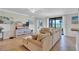 Open-concept living room with a comfortable sofa and a bright, airy atmosphere at 6918 Grand Estuary Trl # 104, Bradenton, FL 34212