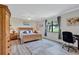 Bedroom with a comfortable bed, natural light, and a workspace at 6918 Grand Estuary Trl # 104, Bradenton, FL 34212