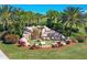 Beautiful water feature at River Strand with lush landscaping and a rock waterfall, enhancing the community's appeal at 6918 Grand Estuary Trl # 104, Bradenton, FL 34212