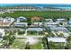 Wide aerial view showcasing homes on canals, some with pools, and lush landscaping in a waterfront community at 726 Jungle Queen Way, Longboat Key, FL 34228