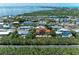 Scenic aerial view of a two story home with a terracotta roof nestled on a canal in a waterfront community at 726 Jungle Queen Way, Longboat Key, FL 34228