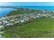 Expansive aerial shot featuring lush greenery and coastal homes with canal access to the beautiful waterfront community at 726 Jungle Queen Way, Longboat Key, FL 34228