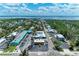 Overhead shot of a commercial district highlighting storefronts and parking areas near a coastal landscape at 726 Jungle Queen Way, Longboat Key, FL 34228