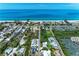 An aerial shot featuring this home close to the beach, showcasing its proximity to both the ocean and commercial establishments at 726 Jungle Queen Way, Longboat Key, FL 34228