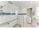 Modern bathroom featuring a glass-enclosed shower with blue accents at 726 Jungle Queen Way, Longboat Key, FL 34228