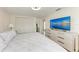 Inviting bedroom with closet, TV and ceiling fan at 726 Jungle Queen Way, Longboat Key, FL 34228