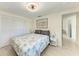 Bright bedroom with ceiling fan, closet, and light wood floors at 726 Jungle Queen Way, Longboat Key, FL 34228