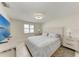 Bright bedroom with a large television, neutral decor, and view of the outdoors at 726 Jungle Queen Way, Longboat Key, FL 34228
