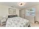 Inviting bedroom featuring a ceiling fan, closet, and white dresser at 726 Jungle Queen Way, Longboat Key, FL 34228