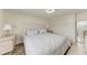 Cozy bedroom featuring a large bed, closet, and light wood floors at 726 Jungle Queen Way, Longboat Key, FL 34228
