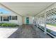 Covered carport area offering protection from the elements and convenient access to the home's inviting entrance at 726 Jungle Queen Way, Longboat Key, FL 34228