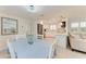 Inviting dining area with kitchen views, white cabinets, and stainless steel appliances at 726 Jungle Queen Way, Longboat Key, FL 34228