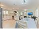 Open layout of kitchen, dining, and living spaces with modern finishes and ample lighting at 726 Jungle Queen Way, Longboat Key, FL 34228
