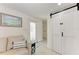 Bright foyer area featuring a stylish sliding barn door, seating, and decor at 726 Jungle Queen Way, Longboat Key, FL 34228
