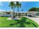 Charming exterior of this inviting waterfront property, showcasing lush landscaping and a convenient covered carport at 726 Jungle Queen Way, Longboat Key, FL 34228
