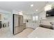 Modern kitchen with stainless steel appliances, white cabinetry, and granite countertops at 726 Jungle Queen Way, Longboat Key, FL 34228