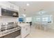 Stylish kitchen with stainless appliances, granite counters, and an adjacent dining area at 726 Jungle Queen Way, Longboat Key, FL 34228