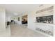 Open-concept living room with a dry bar, light wood floors, and access to other areas of the home at 726 Jungle Queen Way, Longboat Key, FL 34228