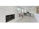 Bright living room with a fireplace, wood floors, home office space, and large windows at 726 Jungle Queen Way, Longboat Key, FL 34228