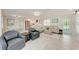 Open-concept living room with neutral tones, stylish furniture, and plenty of natural light at 726 Jungle Queen Way, Longboat Key, FL 34228